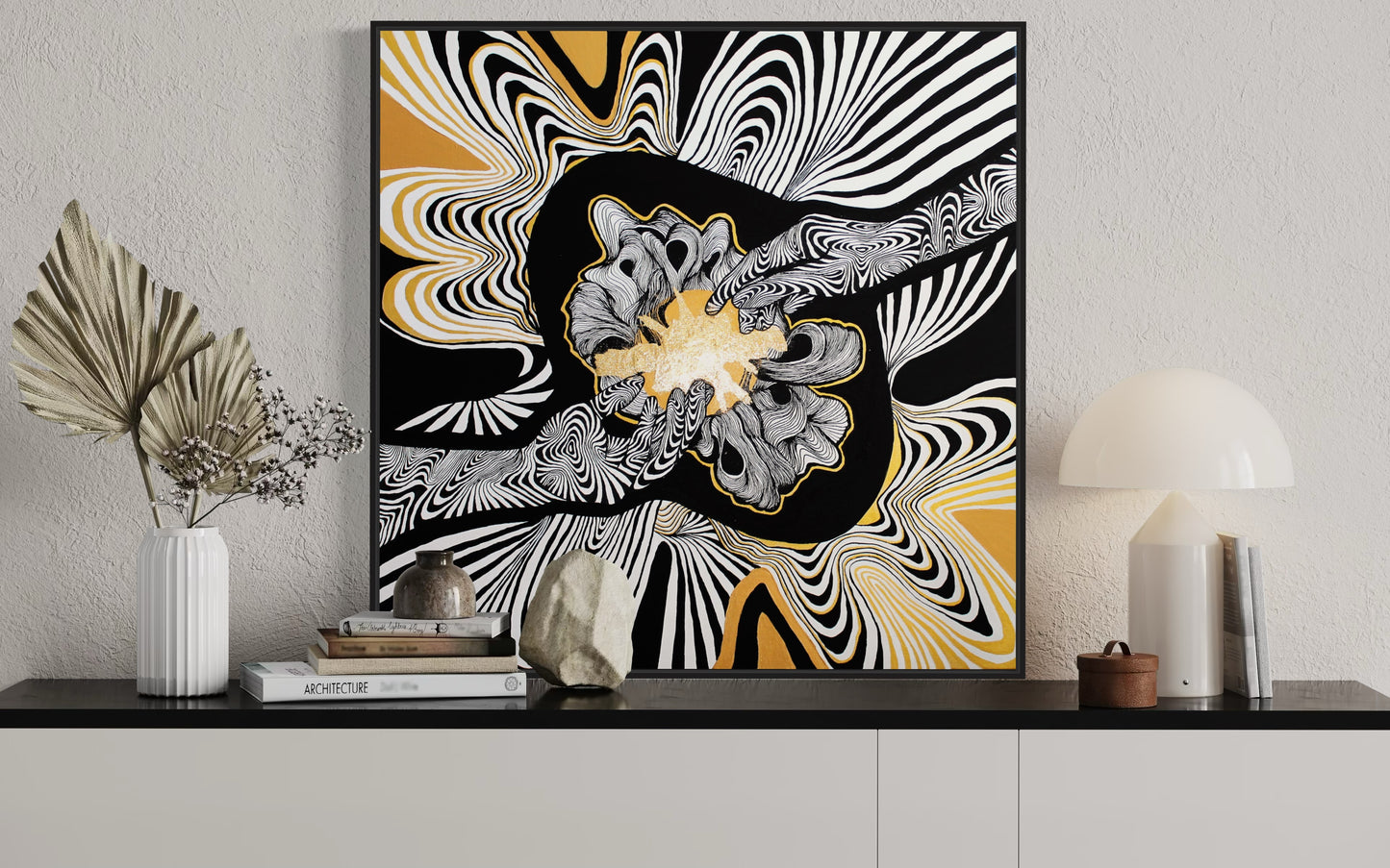 A framed giclée print featuring a abstract design with black and white hands touching and and an explosion of gold light, unravelling fine lines with black, white, gray, and yellow colors.