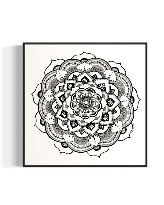 Black and white mandala art print in a black frame on a white background