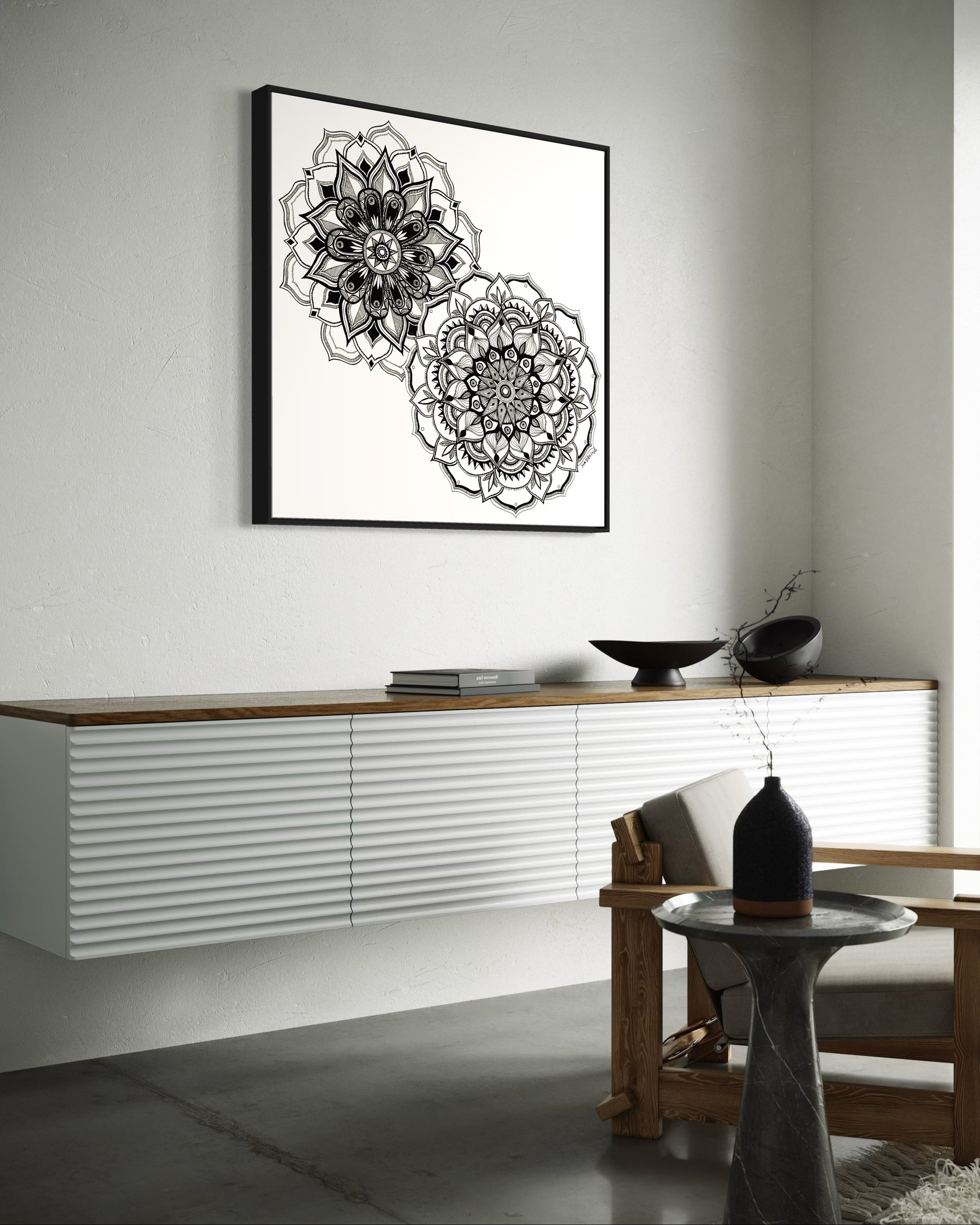 Framed artwork of two black and white mandala flower designs on a white background