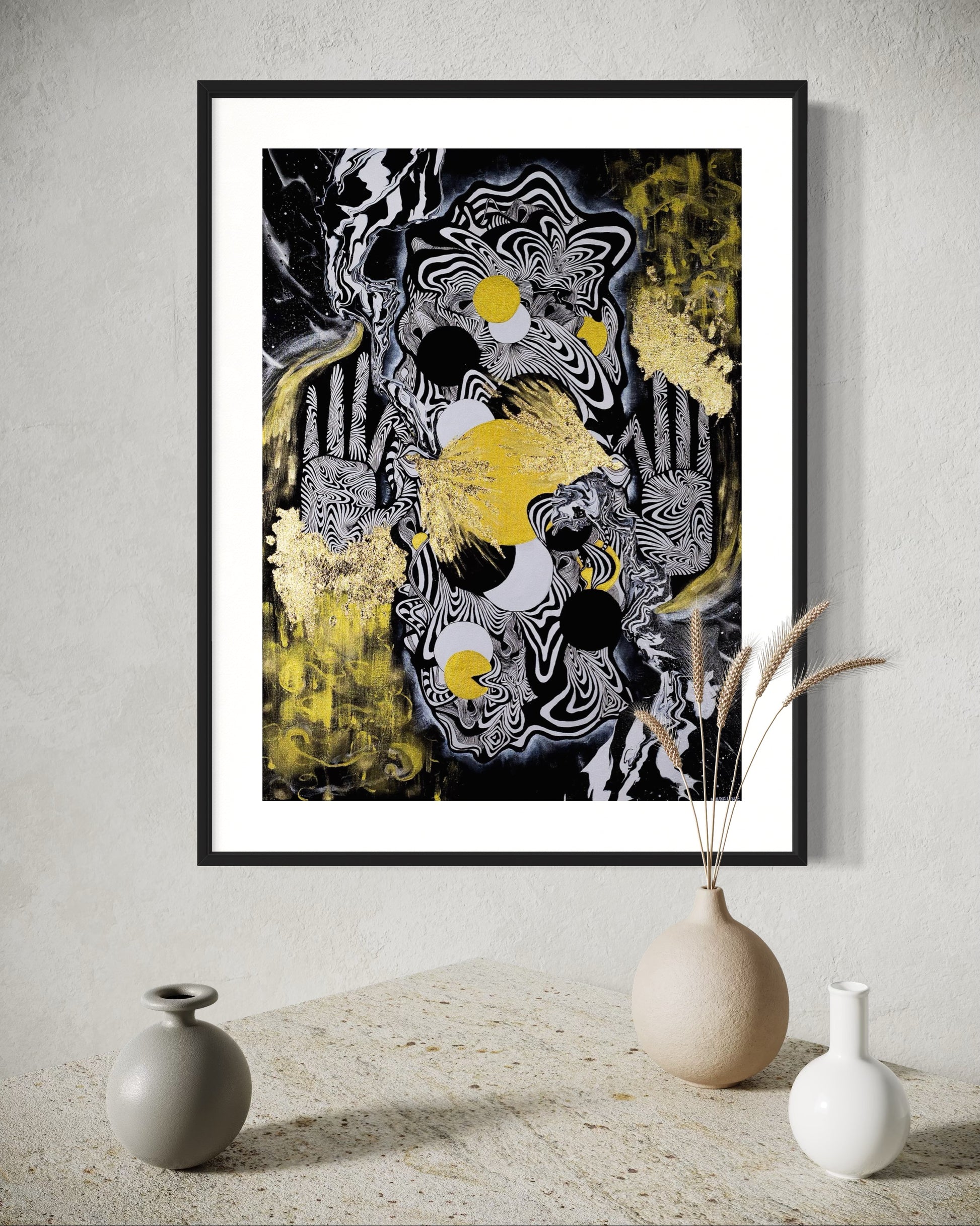 Abstract celestial artwork with black, white, gold and yellow colors with gold leaf, eyes, linework, and abstract hands in a black frame.