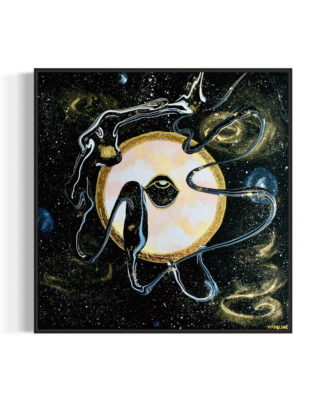 Framed black and gold artwork of a celestial night space scene with a planet and eye against a starry background.