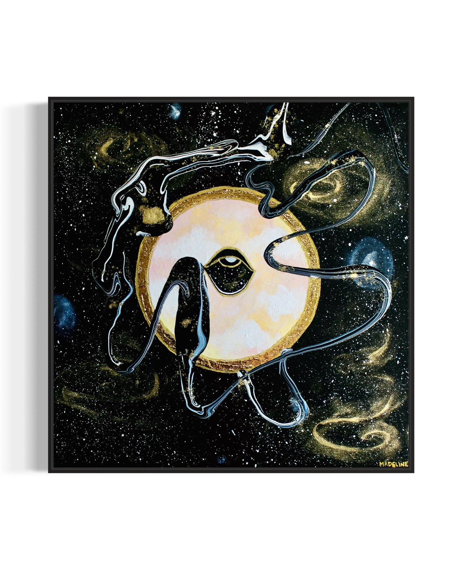 Framed black and gold artwork of a celestial night space scene with a planet and eye against a starry background.