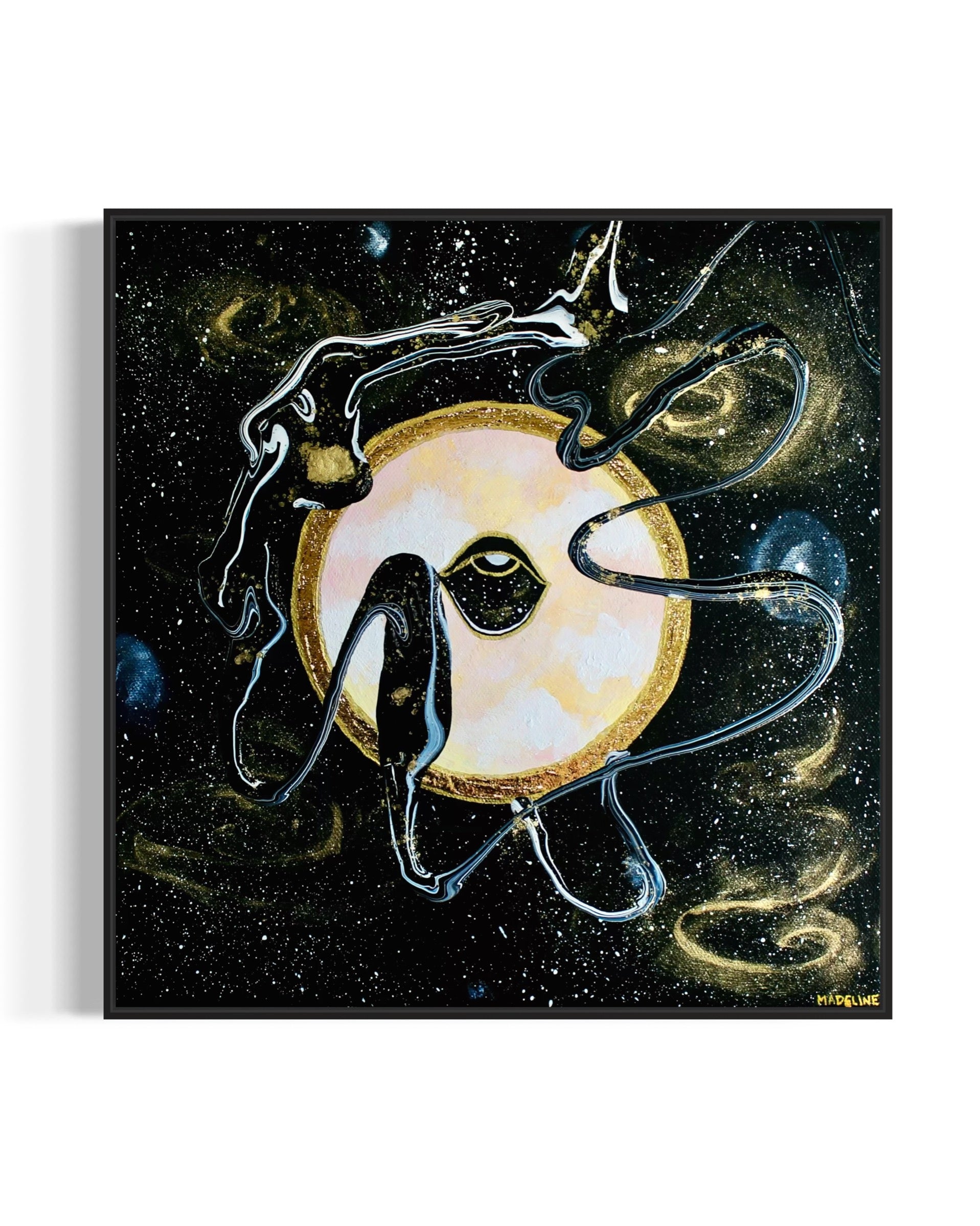 Framed black and gold artwork of a celestial night space scene with a planet and eye against a starry background.