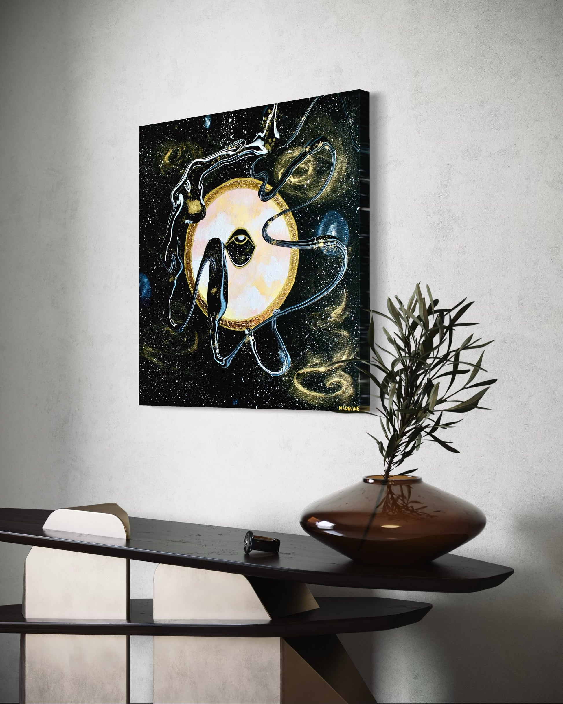 Framed black and gold artwork of a celestial night space scene with a planet and eye against a starry background.