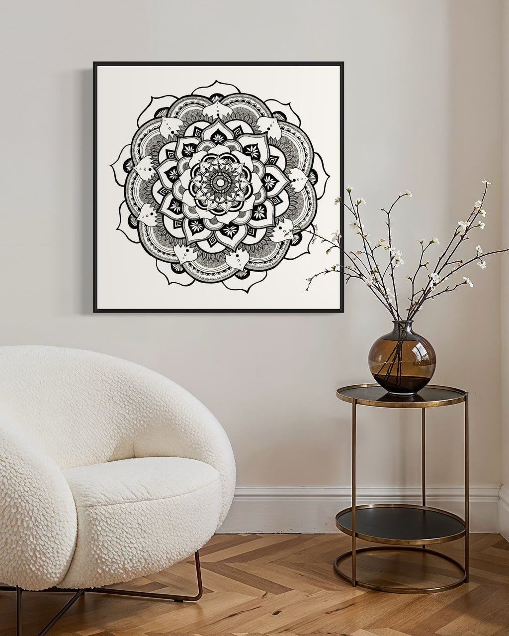 Black and white mandala art print in a black frame on a white background