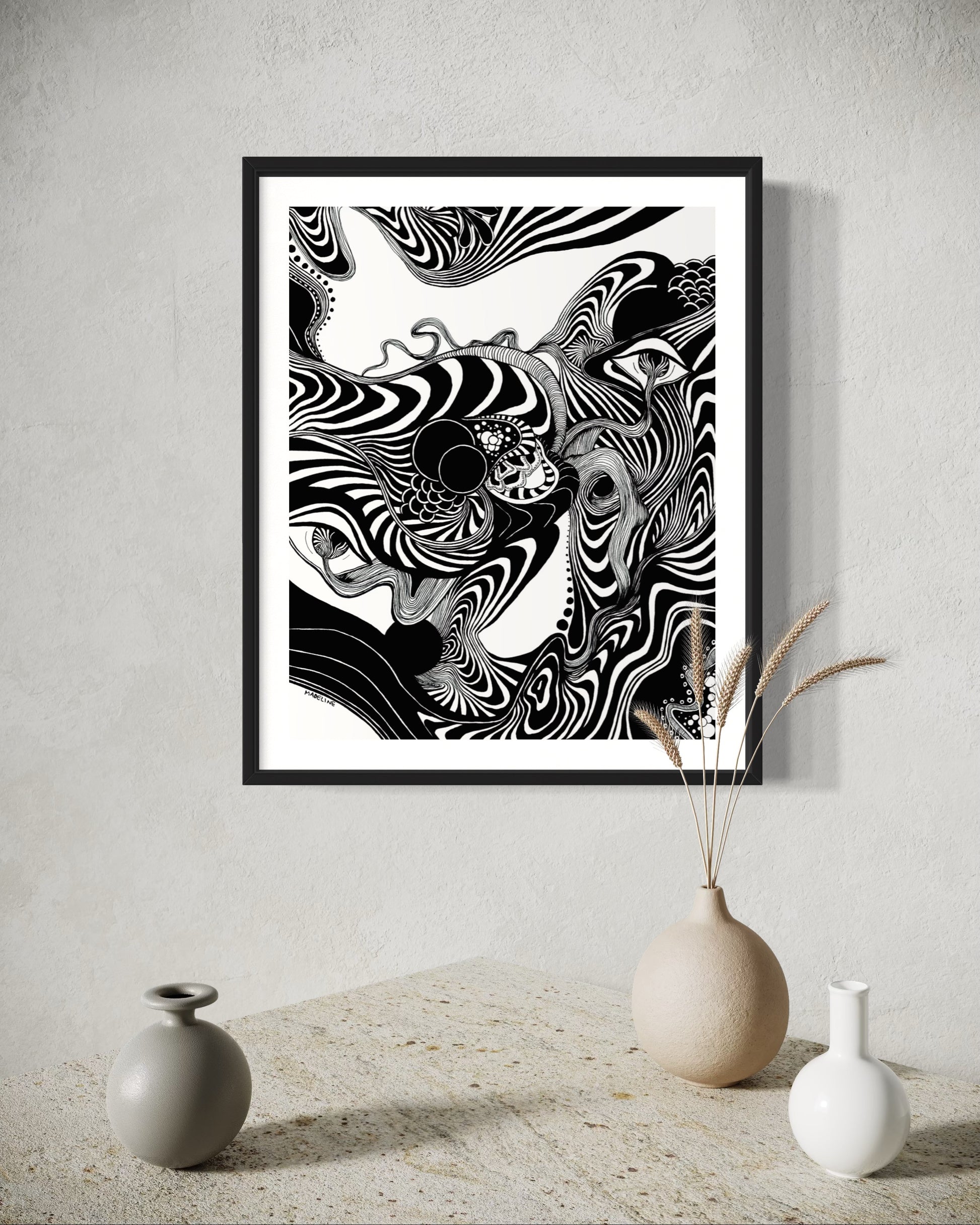 Framed black and white abstract artwork of flowing whimsical linework patterns coming out of eyes