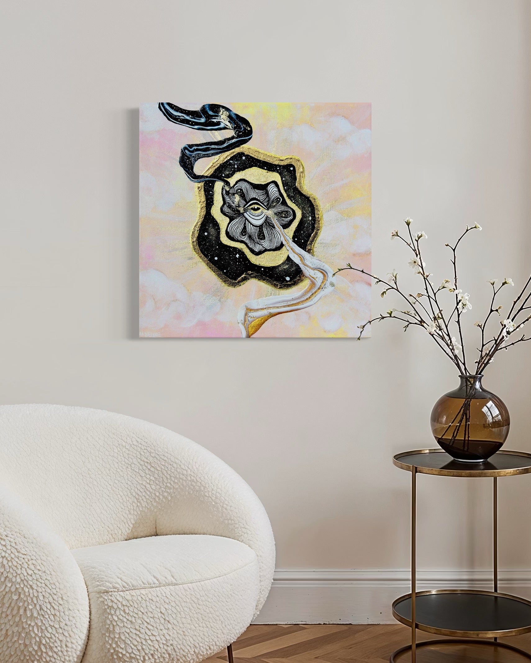 Framed artwork with a black and gold abstract swirls coming out of golden eye on a night sky over a pastel pink and yellow sky background