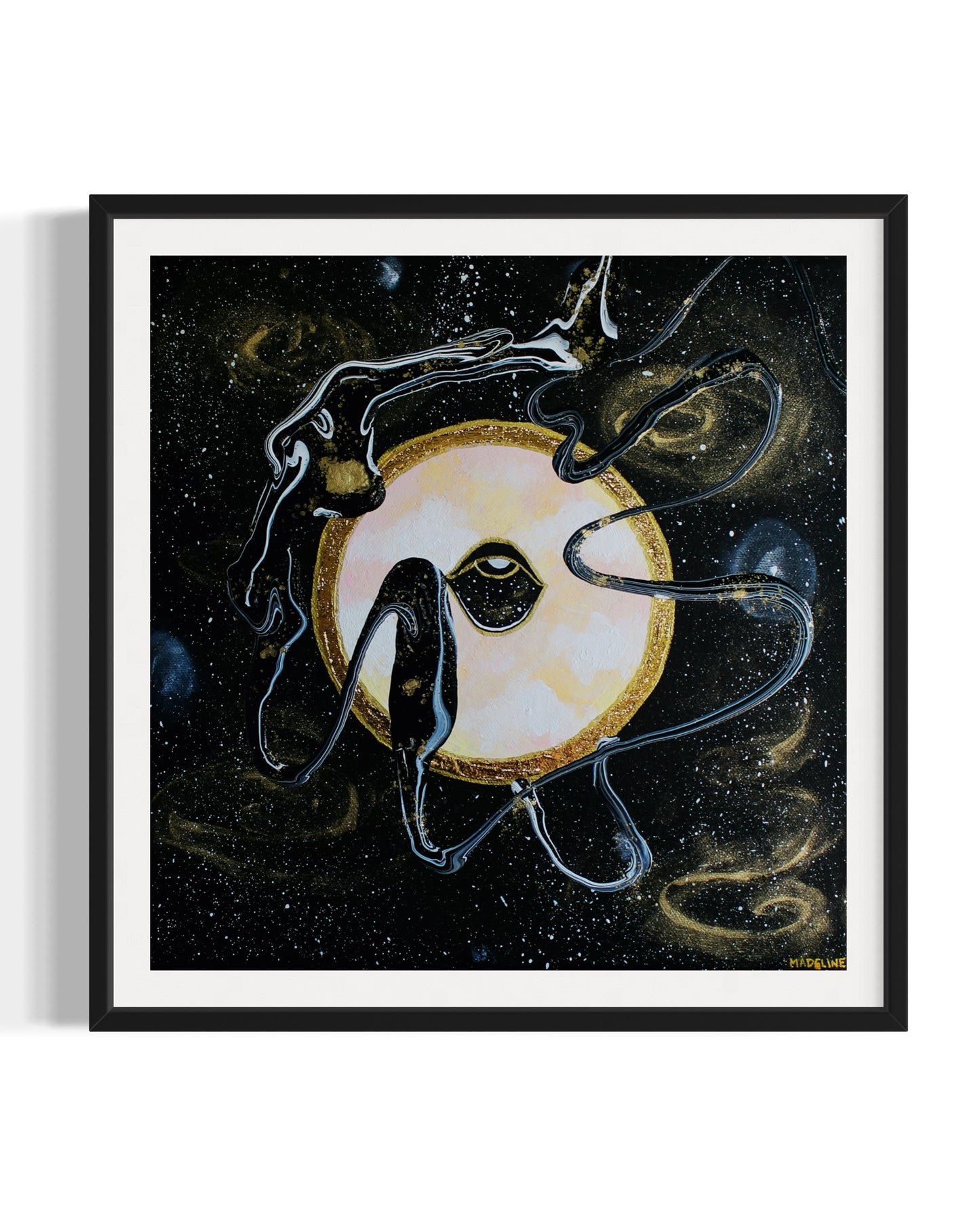 Framed black and gold artwork of a celestial night space scene with a planet and eye against a starry background.