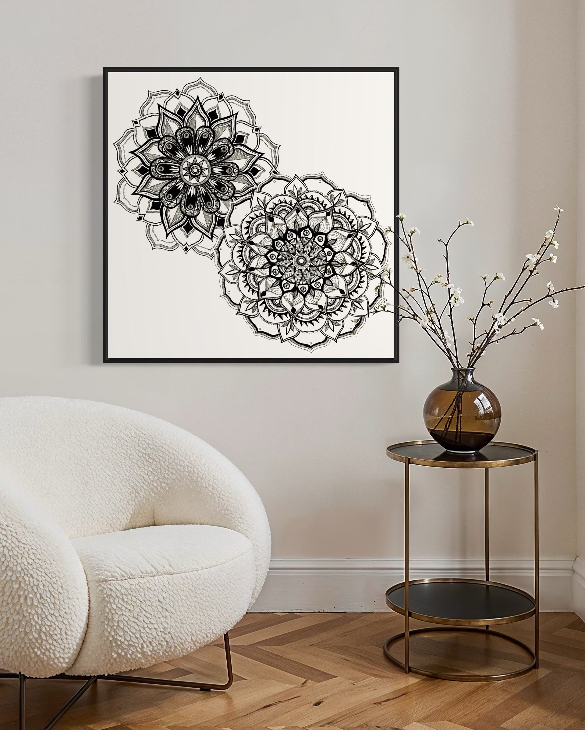 Framed artwork of two black and white mandala flower designs on a white background