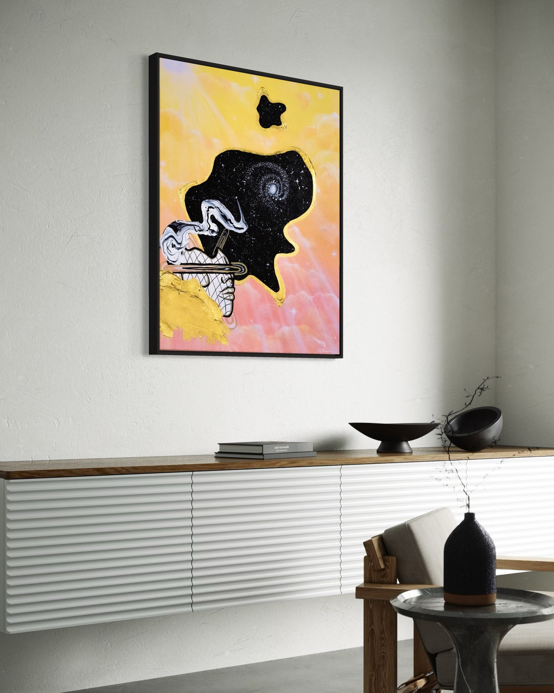 Framed abstract celestial artwork with a black cosmic space bubble, white swirl patterns, a silhouette, and yellow and pink pastel cloud background.