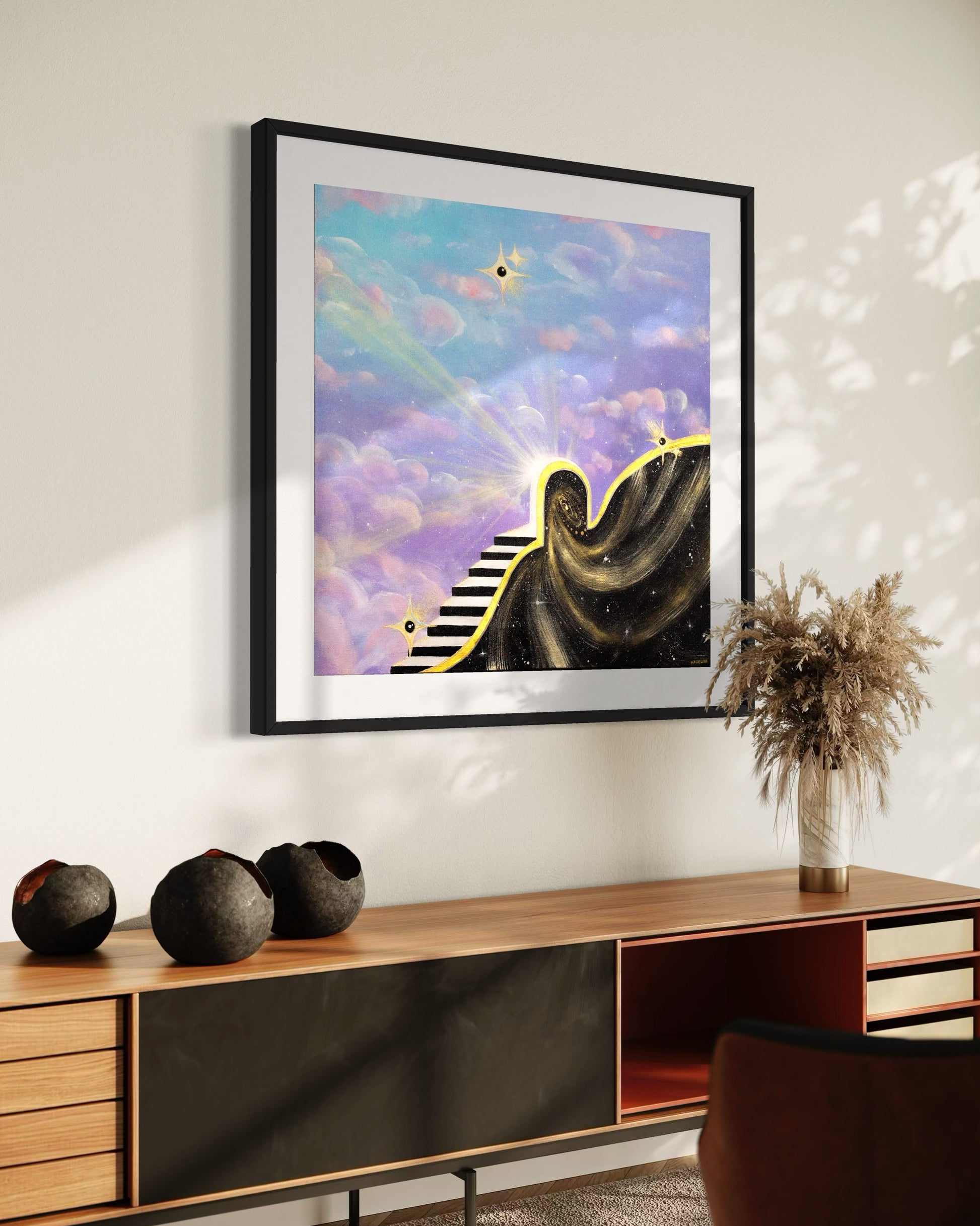 Framed artwork of a staircase leading to a star with light rays and a portal into space with a colorful blue and purple sky with clouds.