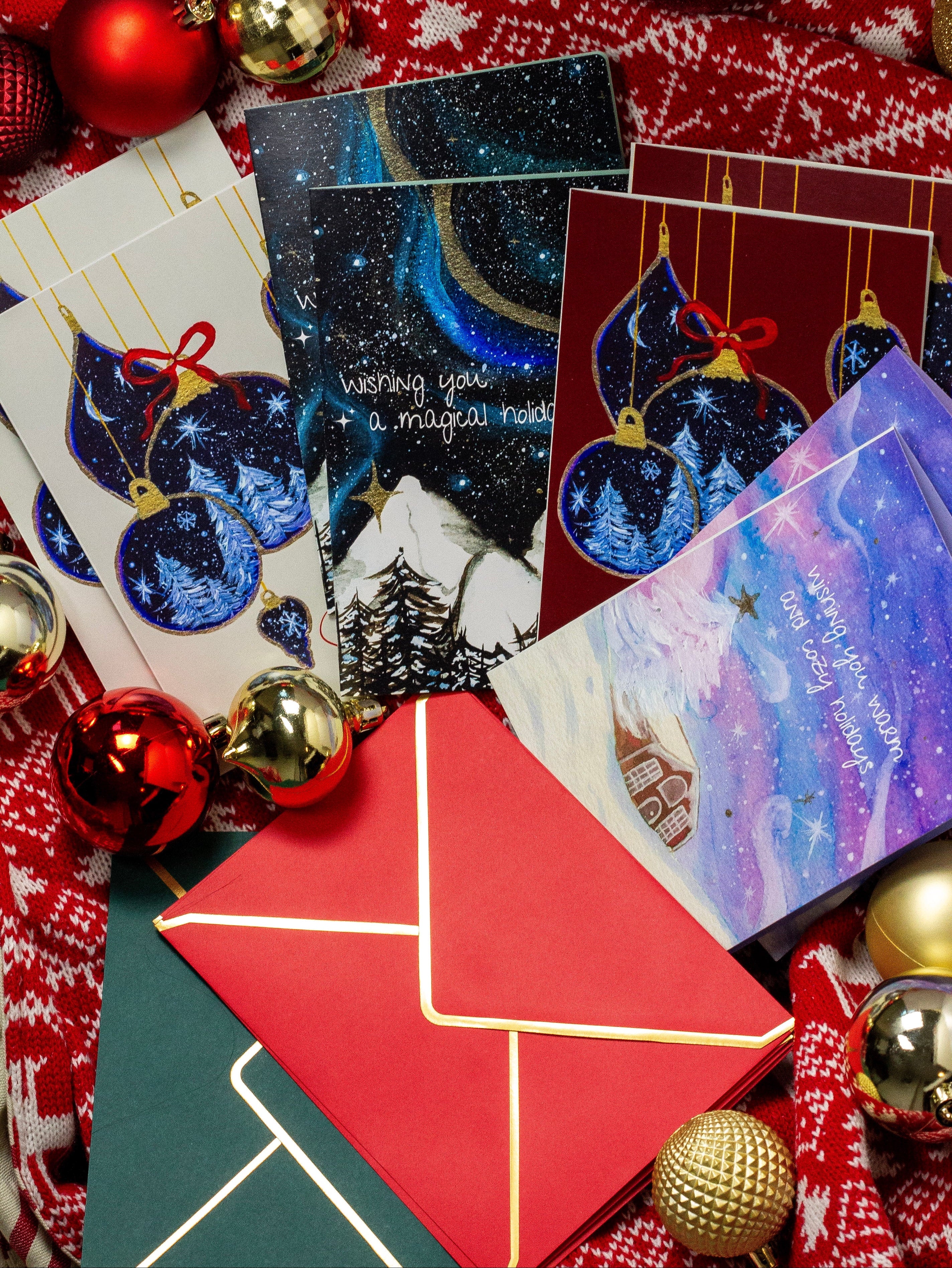 Collection of Christmas-themed cards with decorative ribbons and ornaments on a red fabric background.